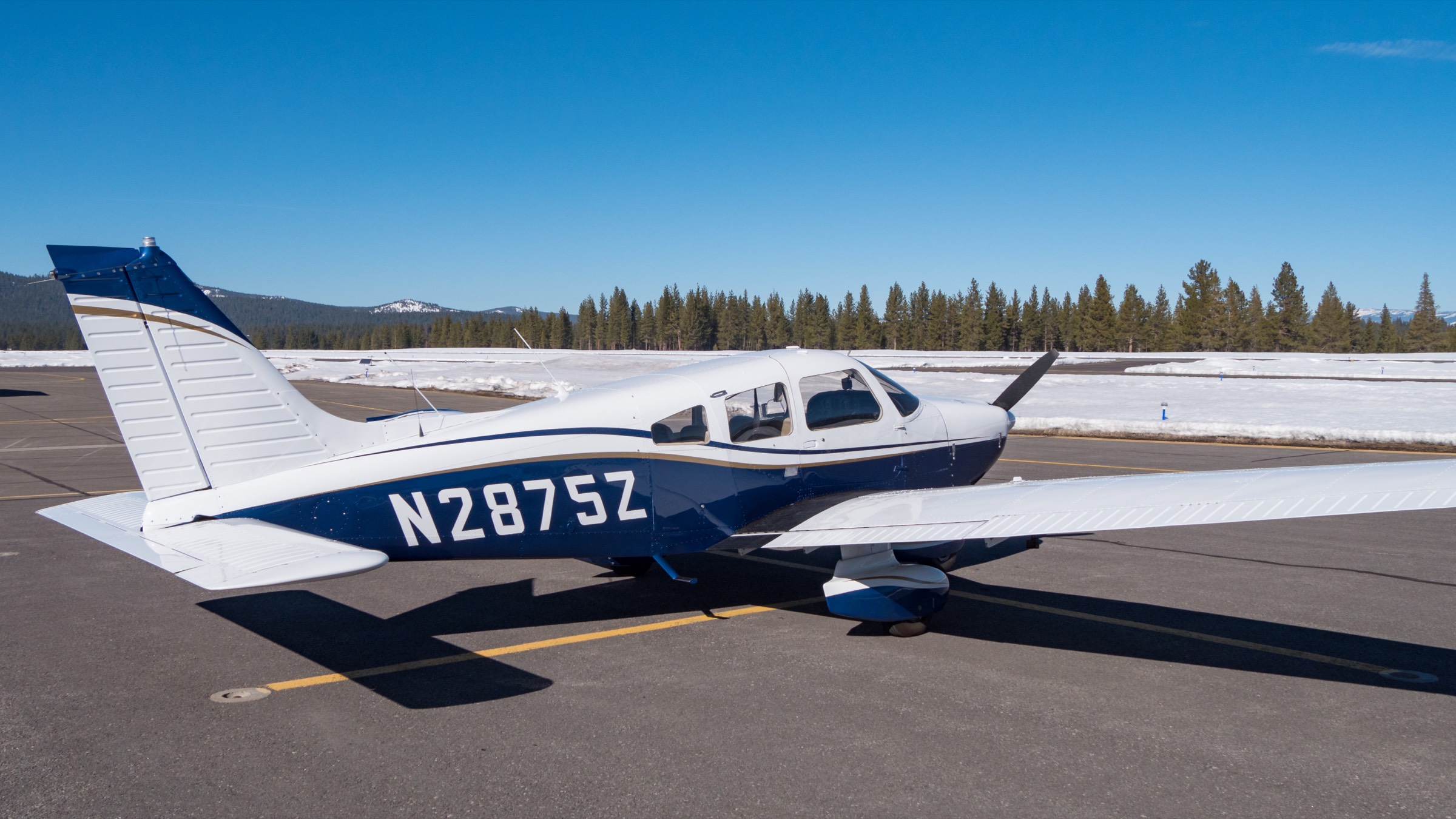 PGAA's Piper Archer N2875Z on the ramp at Lincoln with the snow-covered Sierra Nevada behind